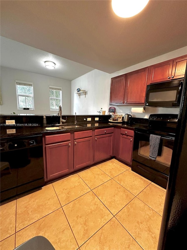 kitchen with black appliances, light tile patterned flooring, and sink