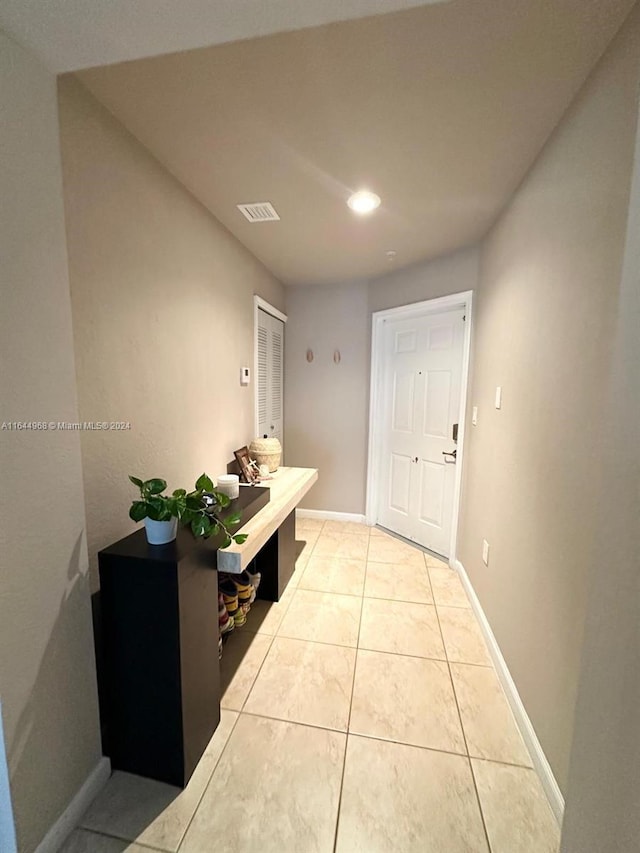 hall with light tile patterned floors