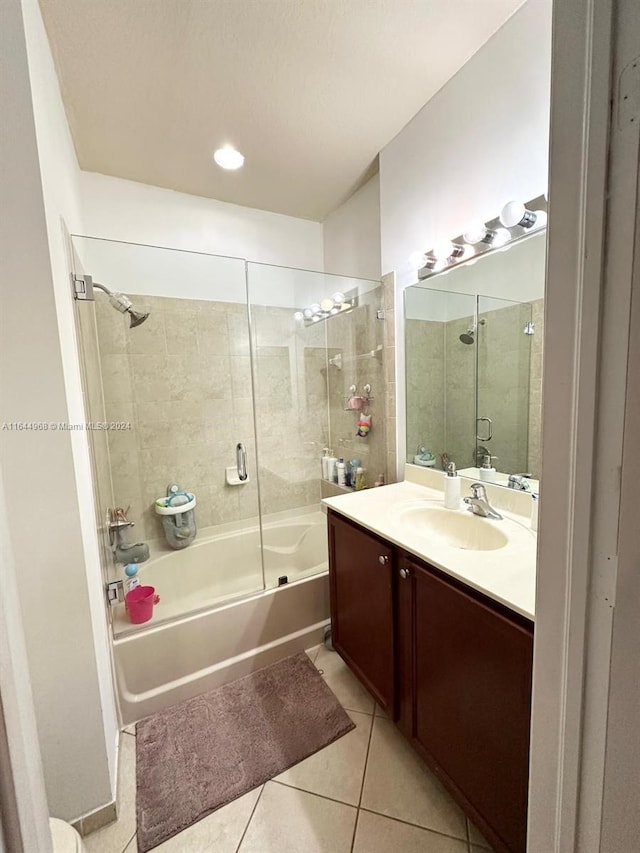 bathroom with vanity, tile patterned flooring, and combined bath / shower with glass door