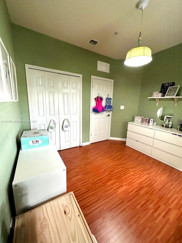 clothes washing area featuring wood-type flooring