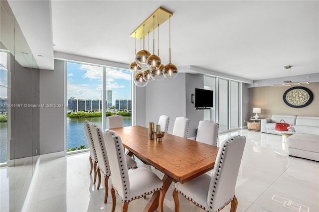 tiled dining space with an inviting chandelier, a healthy amount of sunlight, and floor to ceiling windows