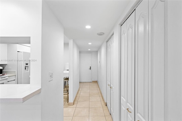 hall with light tile patterned floors