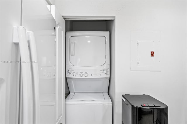 washroom with electric panel and stacked washing maching and dryer