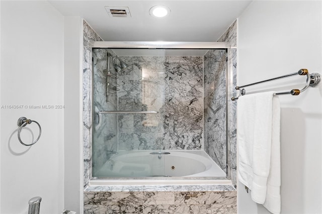 bathroom featuring a relaxing tiled tub