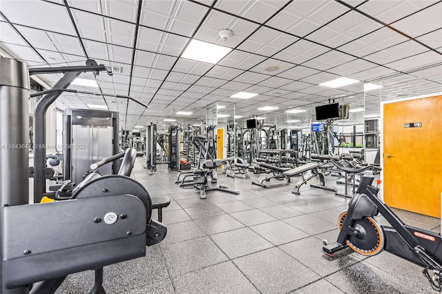 gym with a paneled ceiling