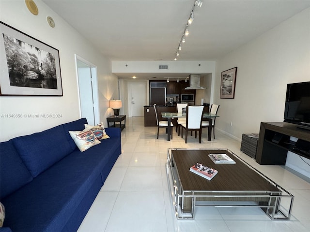 living room featuring light tile patterned floors and rail lighting