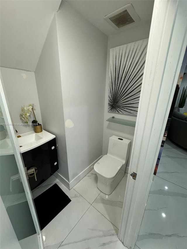 bathroom with toilet and vanity