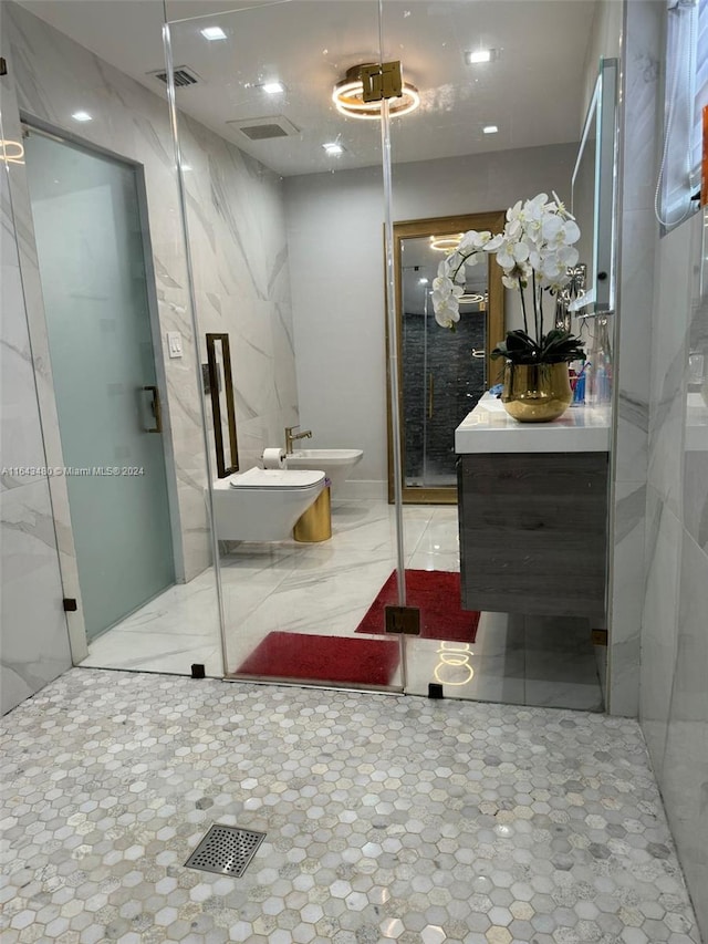 bathroom featuring vanity, toilet, a shower with shower door, and a bidet