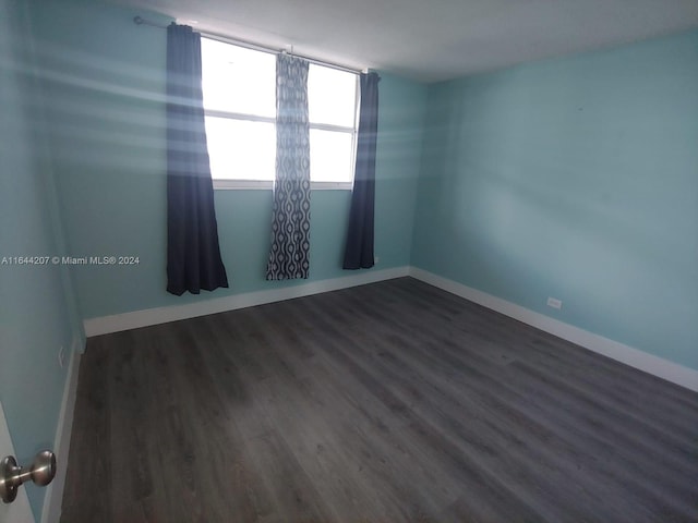 spare room with wood-type flooring