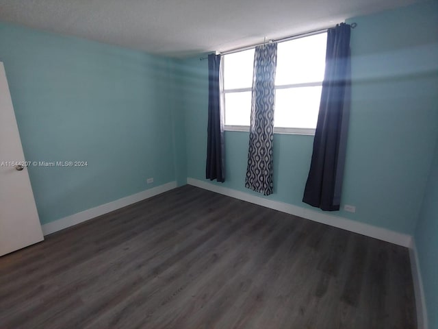 spare room with hardwood / wood-style flooring and a textured ceiling