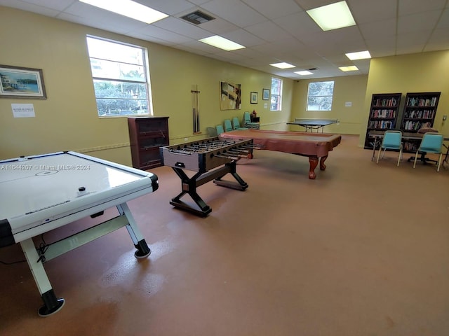 recreation room featuring a paneled ceiling, pool table, and concrete flooring