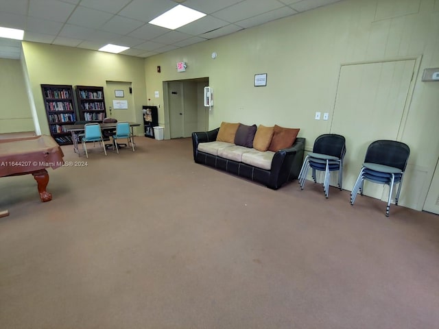 carpeted living room with a paneled ceiling