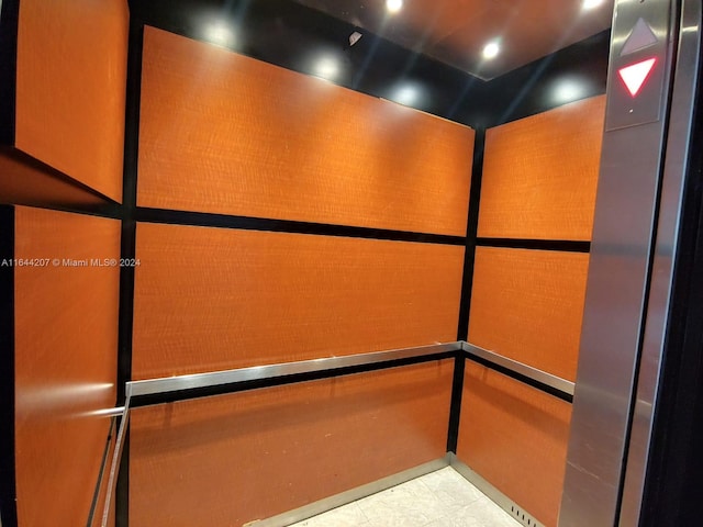 details featuring elevator and tile patterned flooring