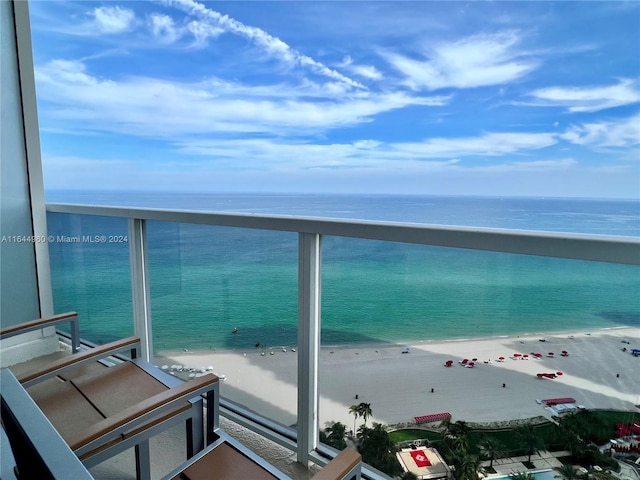 balcony with a water view and a beach view