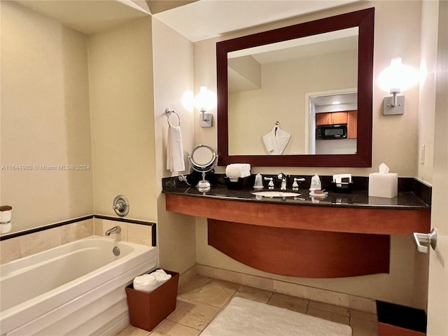 bathroom featuring tile patterned flooring, vanity, and a bathtub