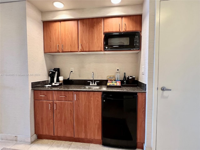 kitchen featuring light tile patterned floors, sink, and black appliances