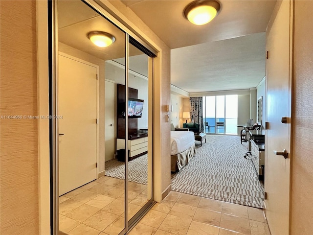 corridor with light tile patterned flooring