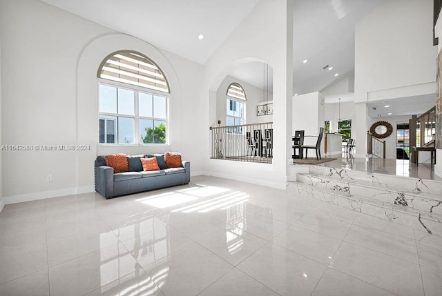 tiled living room featuring high vaulted ceiling