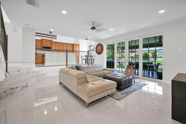 living room featuring ceiling fan and light tile patterned flooring