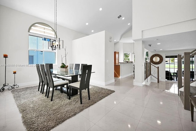 tiled dining area with a chandelier