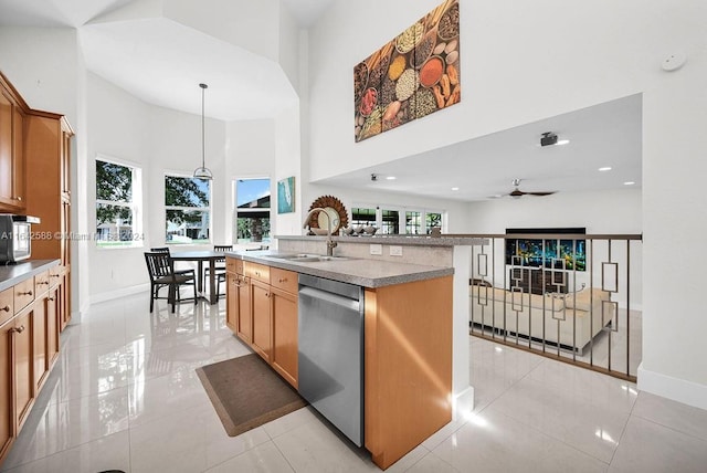 kitchen with a center island with sink, a healthy amount of sunlight, sink, and dishwasher