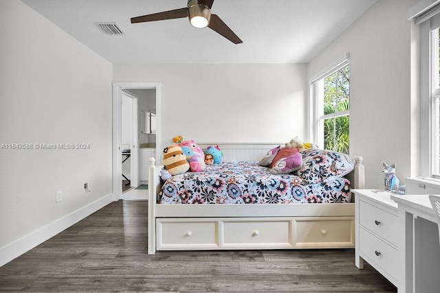 bedroom featuring ceiling fan and dark hardwood / wood-style floors