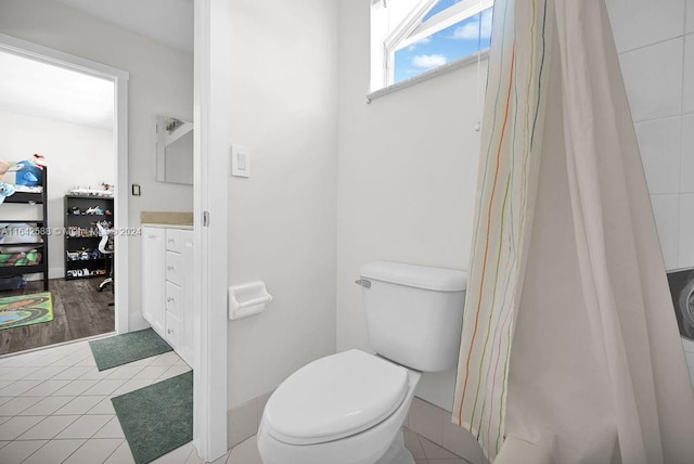 bathroom featuring tile patterned flooring, vanity, and toilet