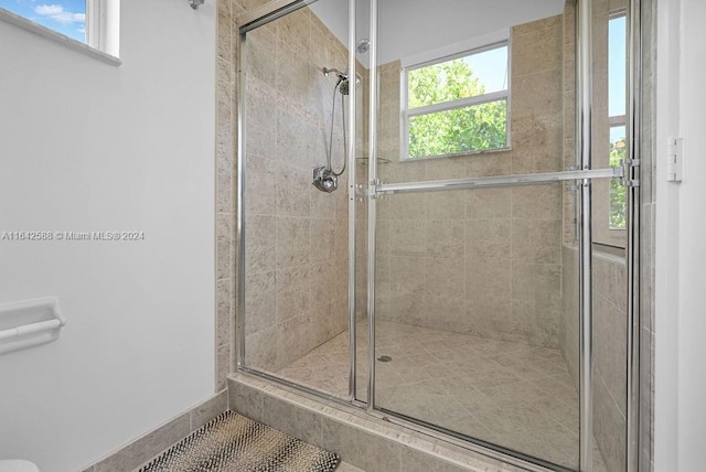 bathroom featuring a shower with door