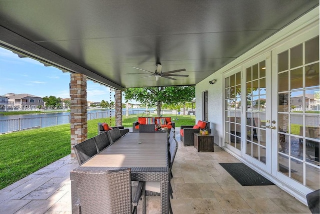 view of patio with ceiling fan, a water view, french doors, and an outdoor hangout area