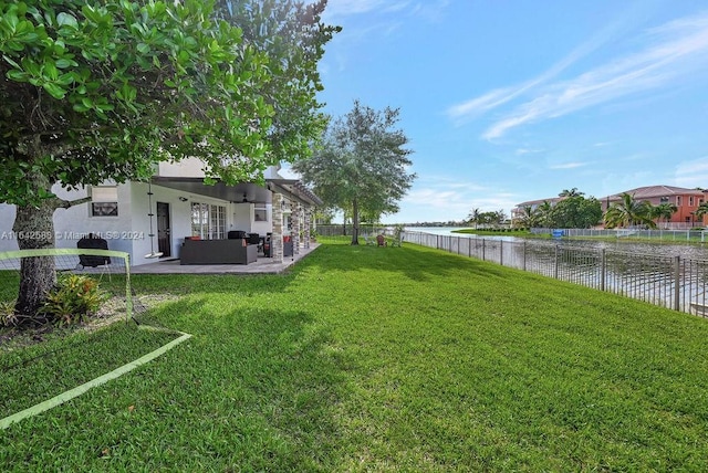 view of yard with a patio, a water view, and an outdoor hangout area