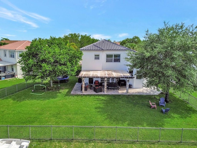 rear view of property with a lawn and a patio