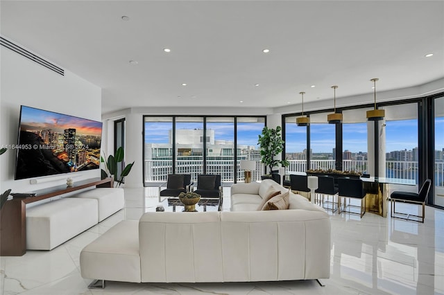 living room with marble finish floor, a view of city, and recessed lighting