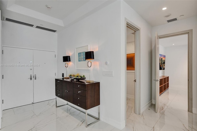 hall featuring light tile patterned flooring