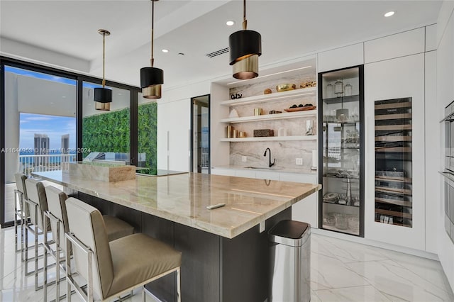 kitchen with a kitchen island, decorative light fixtures, and a breakfast bar