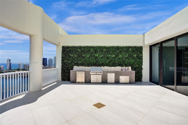 view of patio featuring exterior kitchen and a city view