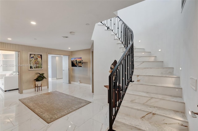 staircase with marble finish floor, baseboards, visible vents, and recessed lighting