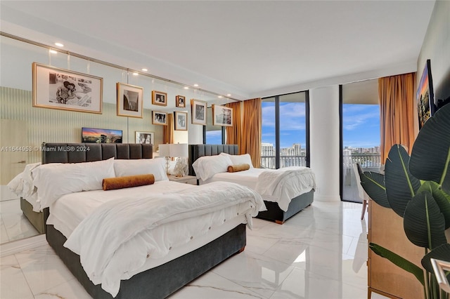 bedroom with a wall of windows, light tile patterned floors, and access to outside