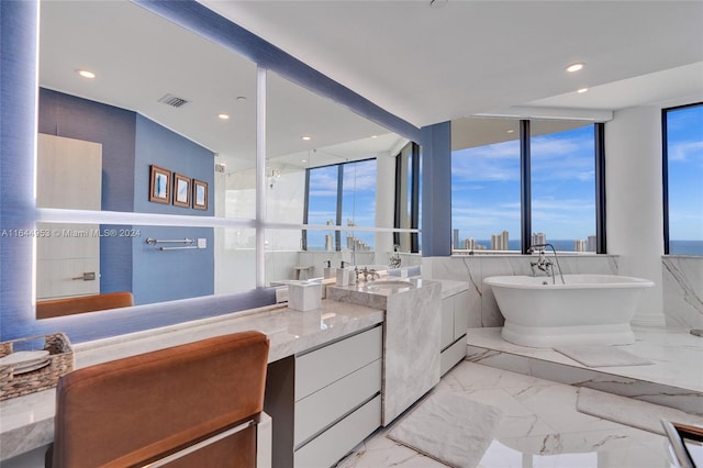 bathroom with expansive windows, a healthy amount of sunlight, and tile patterned floors