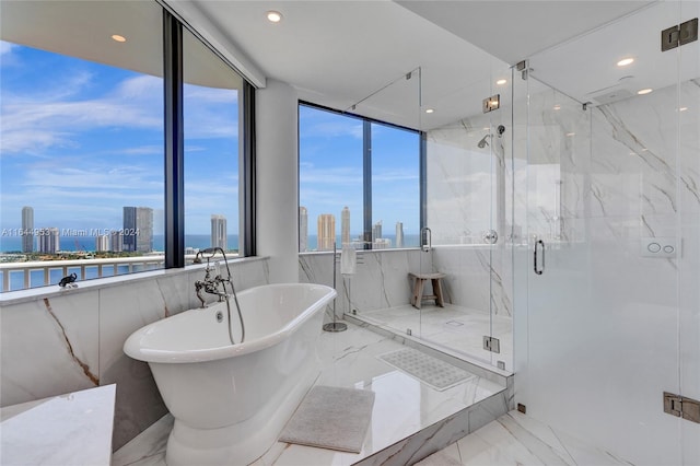 bathroom featuring a wealth of natural light, tile walls, separate shower and tub, and tile patterned floors