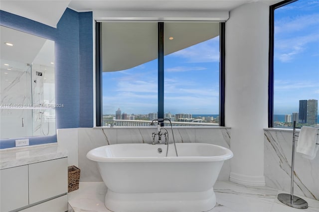 bathroom featuring a wealth of natural light, tile patterned flooring, and tile walls