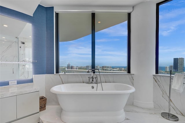 bathroom with marble finish floor, a city view, and plenty of natural light