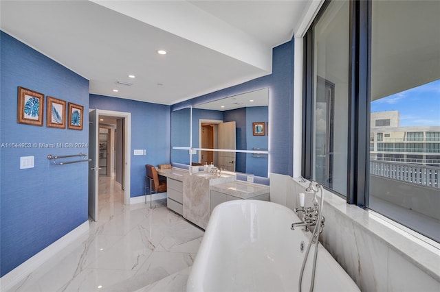 bathroom with a tub, tile patterned floors, and vanity