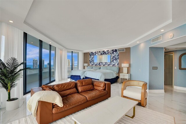 bedroom featuring access to outside, expansive windows, light tile patterned flooring, and a raised ceiling