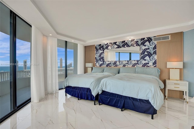 tiled bedroom with multiple windows, a water view, and access to outside