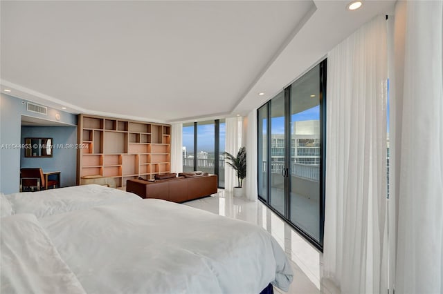 tiled bedroom with a wall of windows and access to exterior