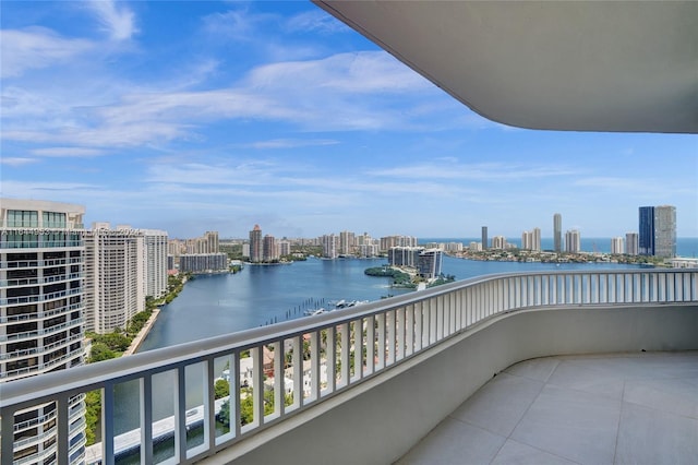 balcony with a water view and a city view