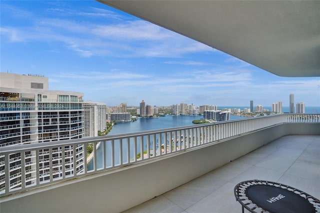 balcony featuring a view of city and a water view