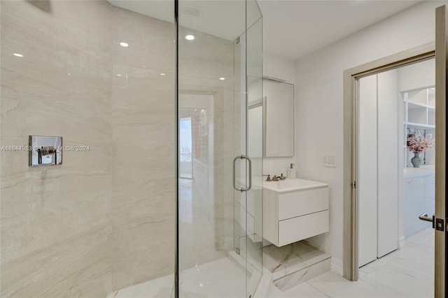 bathroom with tile patterned flooring, walk in shower, and vanity