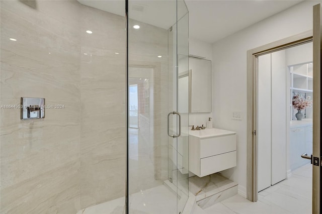 bathroom with a stall shower, marble finish floor, and vanity