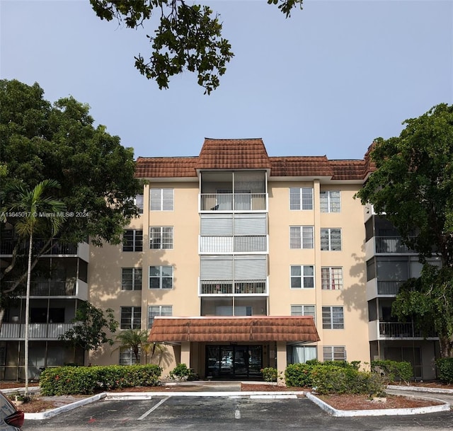 view of property featuring uncovered parking